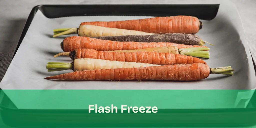Flash freezing carrots in a single layer on a baking sheet to prevent clumping